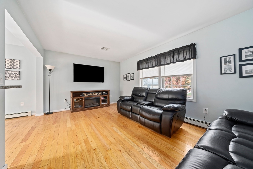 10 Crossman Circle Abington, MA 02351 - Photo 12 of 38 a living room with furniture and a flat screen tv