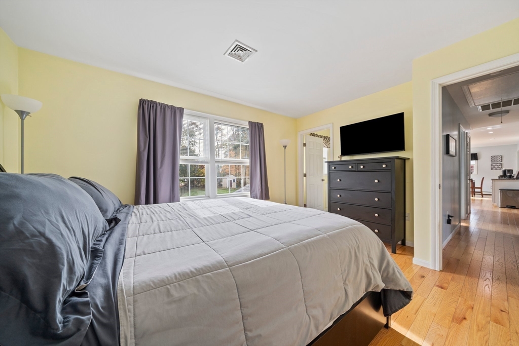10 Crossman Circle Abington, MA 02351 - Photo 16 of 38 a bedroom with a bed and a flat tv screen on dresser