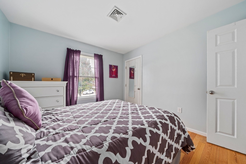 10 Crossman Circle Abington, MA 02351 - Photo 19 of 38 a bedroom with a large bed and a dresser