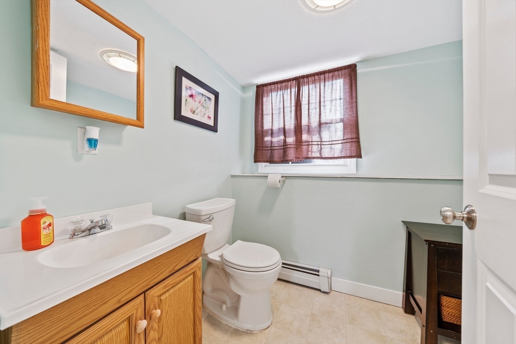 10 Crossman Circle Abington, MA 02351 - Photo 26 of 38 a bathroom with a toilet sink and mirror