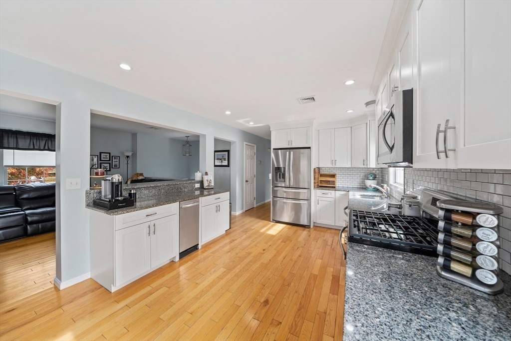 10 Crossman Circle Abington, MA 02351 - Photo 6 of 38 a kitchen with stainless steel appliances kitchen island granite countertop a stove and a sink