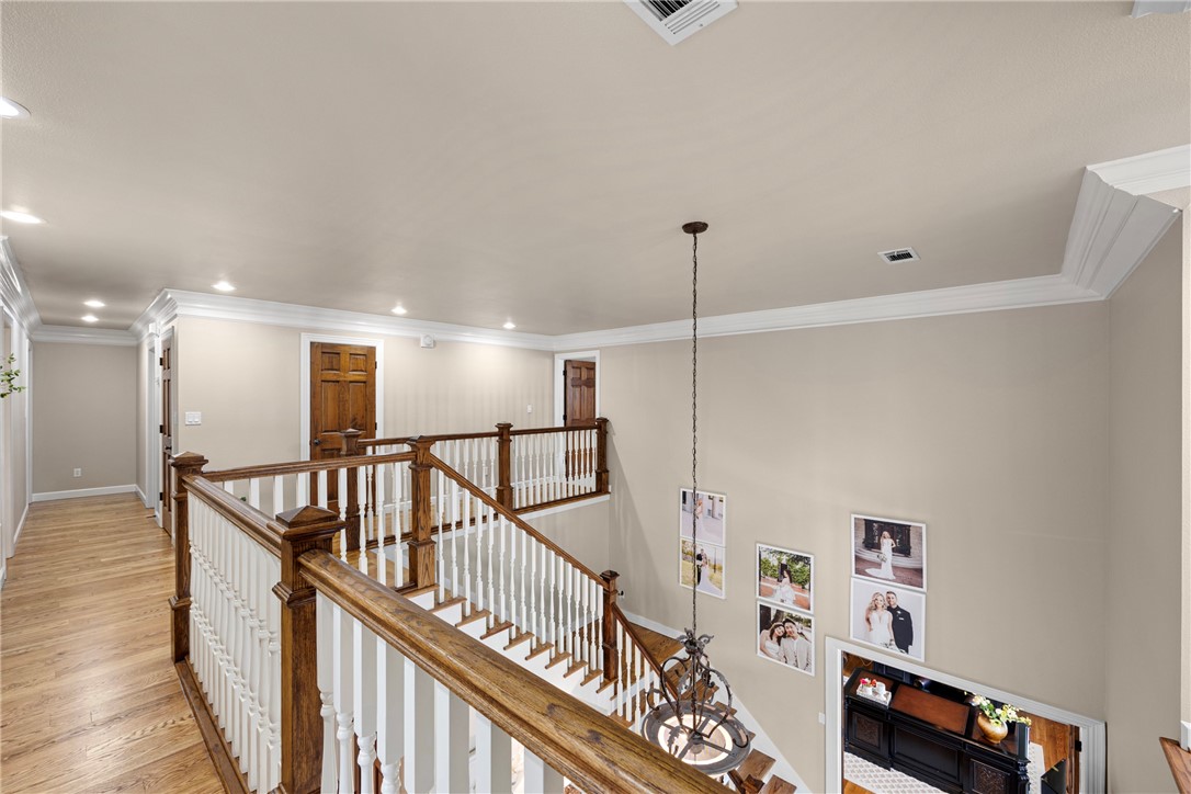 788 Cliff Road Russellville, AR 72802 - Photo 32 of 60 Corridor with an upstairs landing, light wood finished floors, recessed lighting, and crown molding