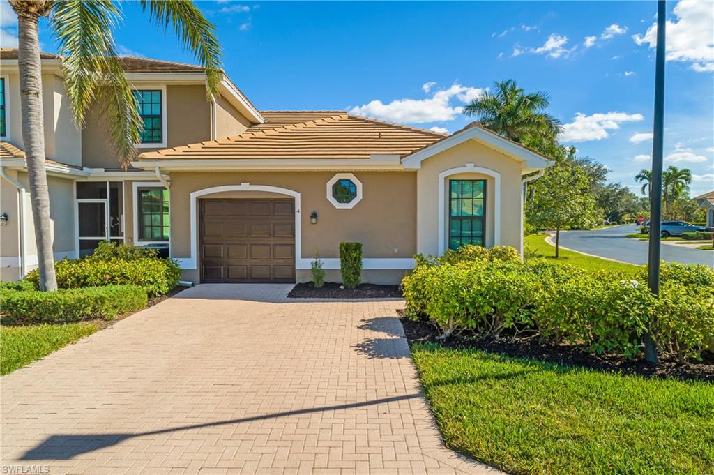 7820 Sandpine Court, Unit 2304 Naples, FL 34104 - Photo 1 of 49 a front view of a house with a yard and garage