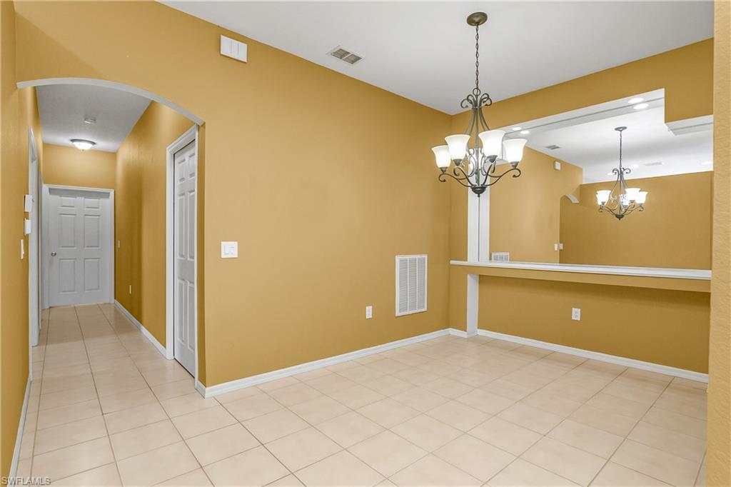 7820 Sandpine Court, Unit 2304 Naples, FL 34104 - Photo 14 of 49 a view of a livingroom with a chandelier and a chandelier