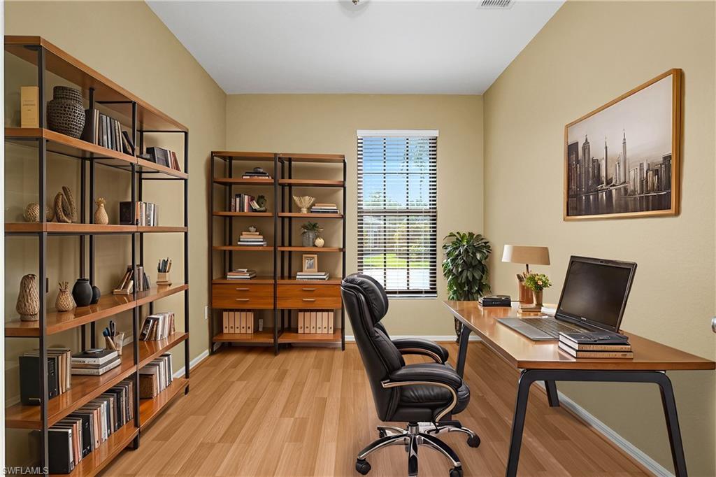 7820 Sandpine Court, Unit 2304 Naples, FL 34104 - Photo 25 of 49 a view of a workspace with furniture and a bookshelf