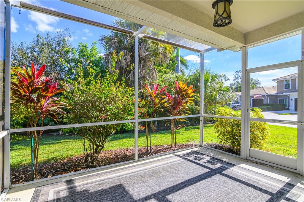 7820 Sandpine Court, Unit 2304 Naples, FL 34104 - Photo 30 of 49 a view of a porch with a floor to ceiling windows and a yard