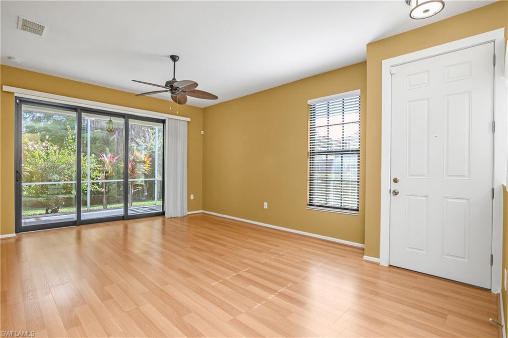 7820 Sandpine Court, Unit 2304 Naples, FL 34104 - Photo 33 of 49 a view of an empty room with wooden floor and a window