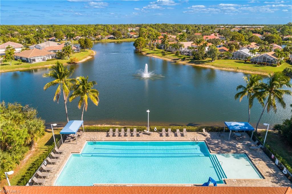 7820 Sandpine Court, Unit 2304 Naples, FL 34104 - Photo 37 of 49 a view of a lake with a table and chairs