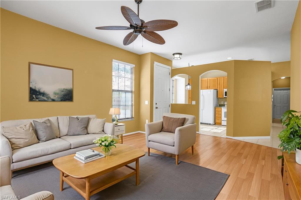 7820 Sandpine Court, Unit 2304 Naples, FL 34104 - Photo 4 of 49 a living room with furniture and a large window