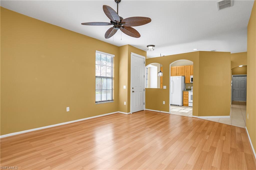 7820 Sandpine Court, Unit 2304 Naples, FL 34104 - Photo 5 of 49 a view of an empty room with window and wooden floor