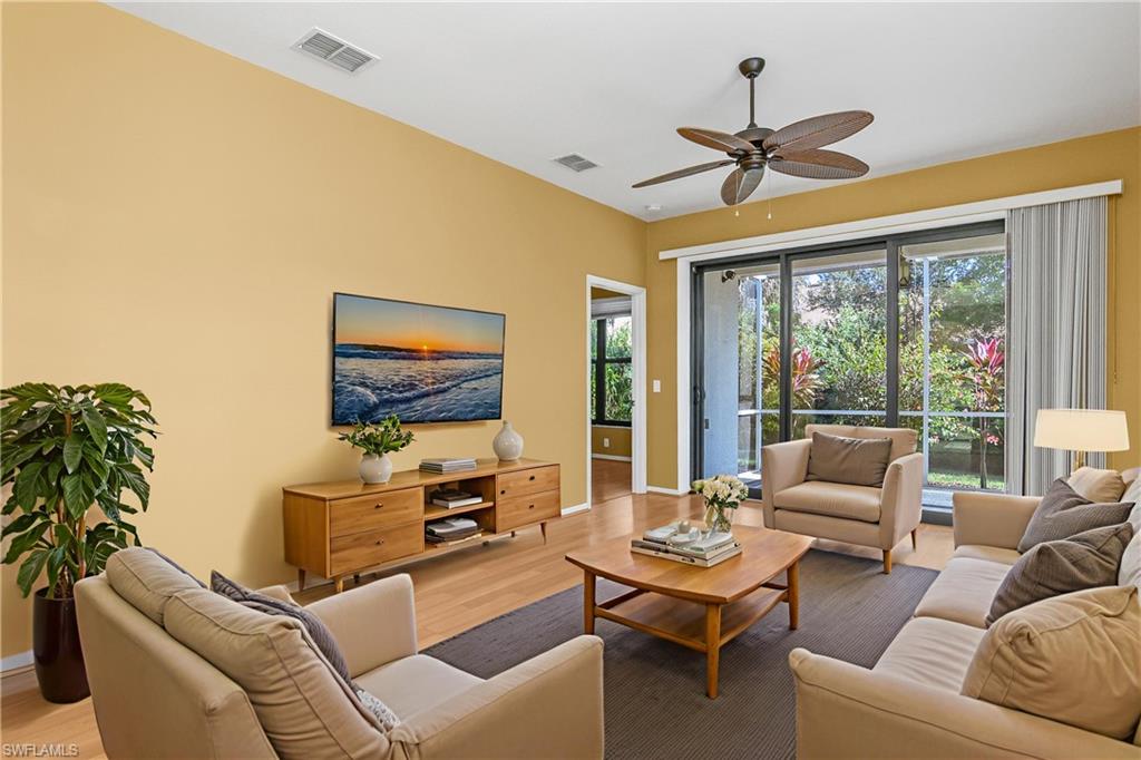 7820 Sandpine Court, Unit 2304 Naples, FL 34104 - Photo 6 of 49 a living room with furniture and a flat screen tv