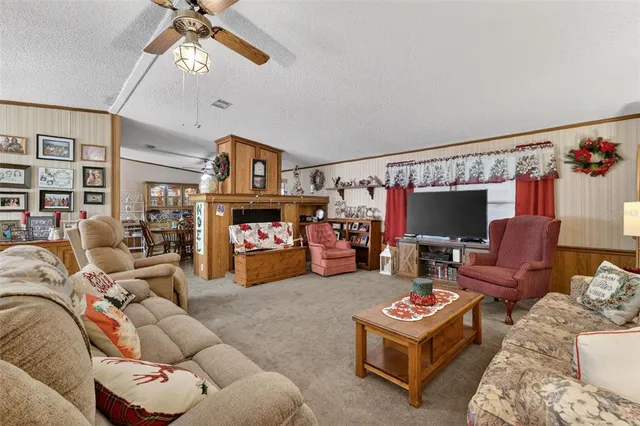 a living room with furniture a flat screen tv and a couch