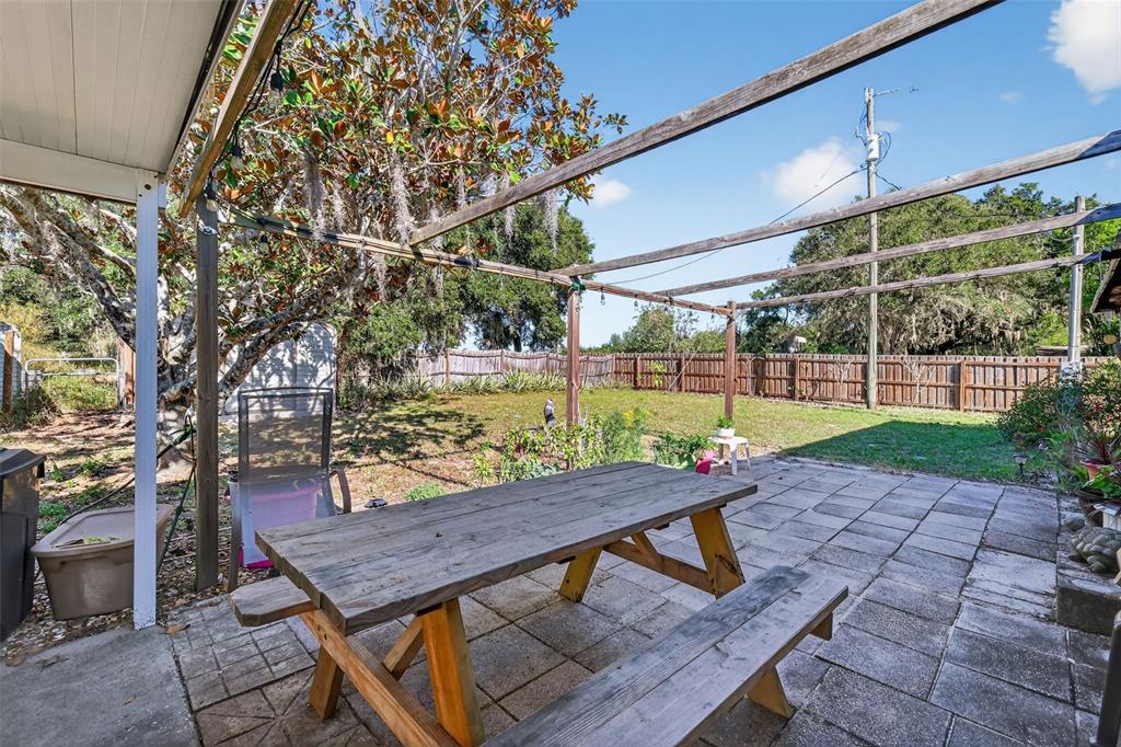 11911 Lane Park Road Tavares, FL 32778 - Photo 21 of 30 a view of a patio with a table and chairs