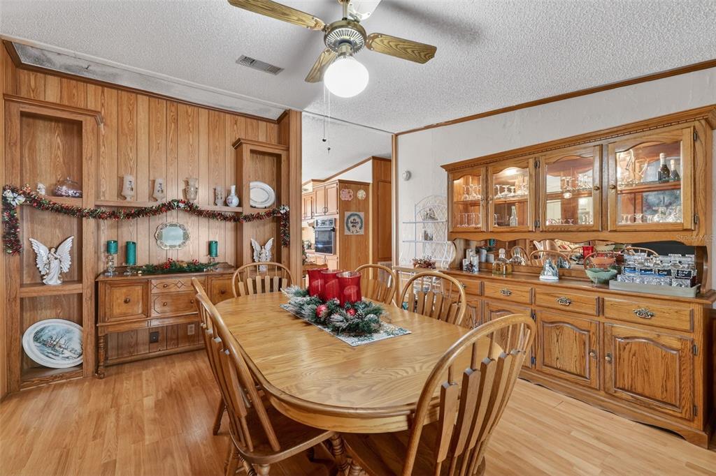 11911 Lane Park Road Tavares, FL 32778 - Photo 7 of 30 a dining room with wooden floor and window