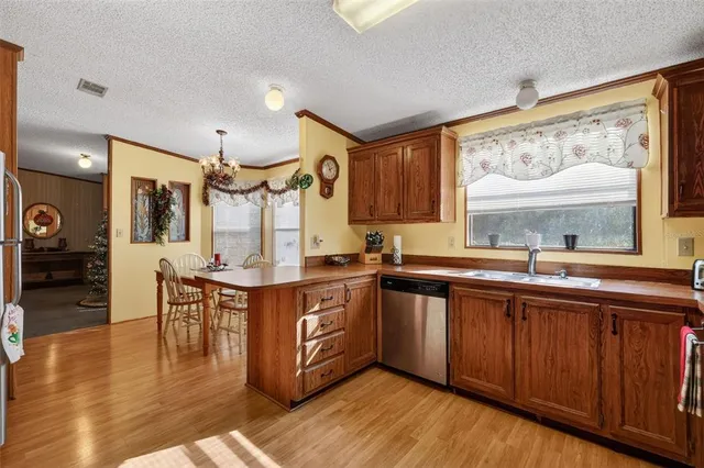 a large kitchen with lots of counter space and painting on the wall