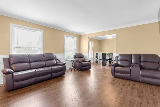 a living room with couches and a large window