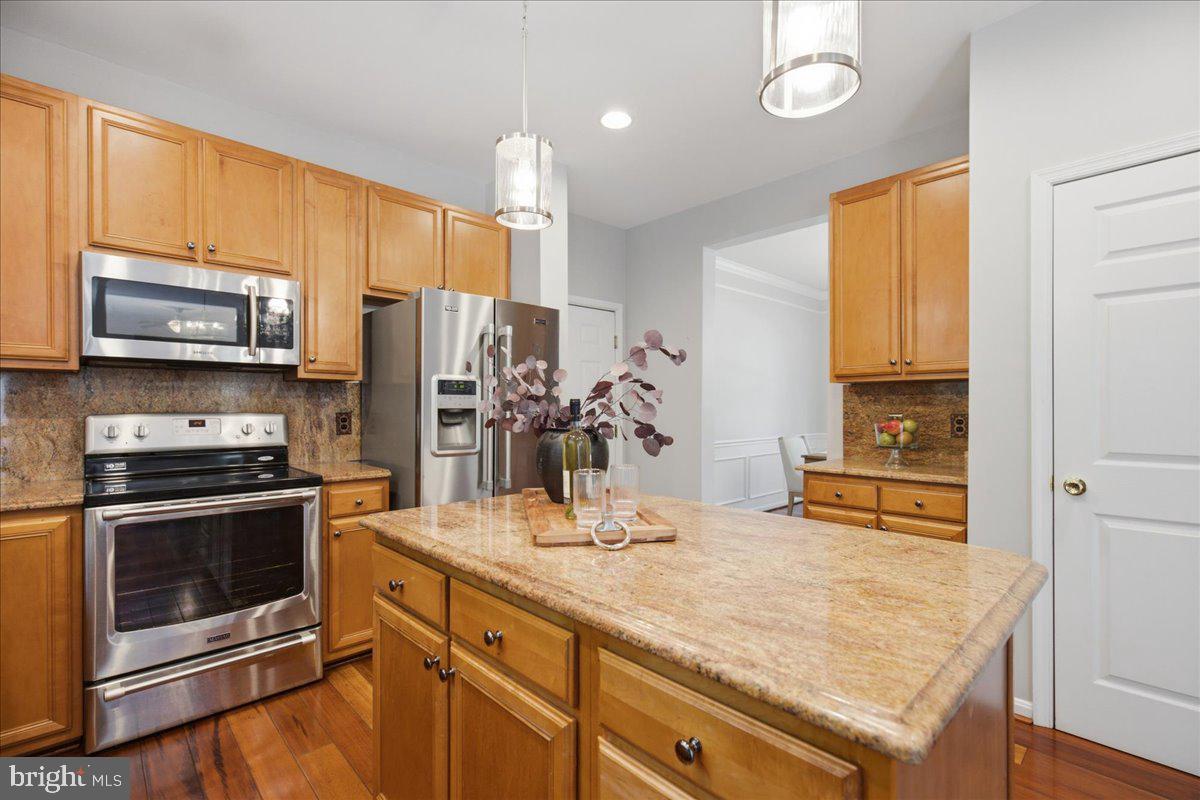2424 Springbrook Court Huntingtown, MD 20639 - Photo 38 of 103 a kitchen with stainless steel appliances a stove microwave and refrigerator