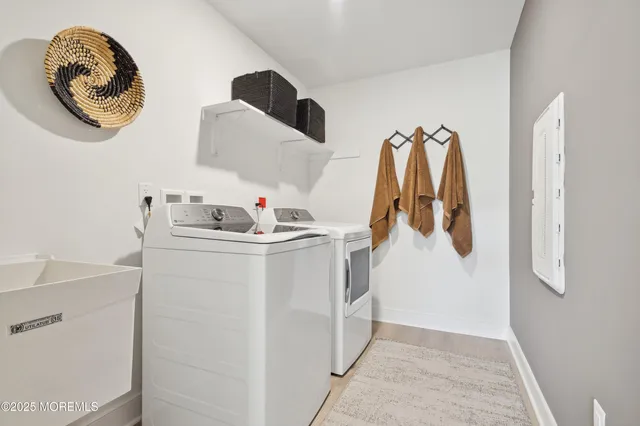 a bathroom with a double vanity sink toilet and a tub