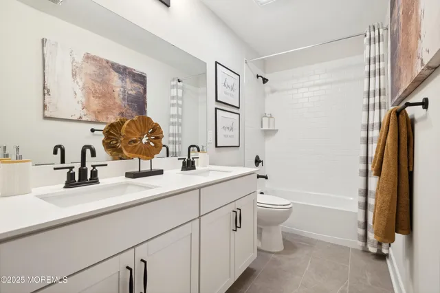 a bedroom with two beds and a lamp