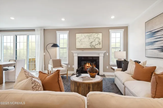 a living room with furniture a fireplace and wall paintings