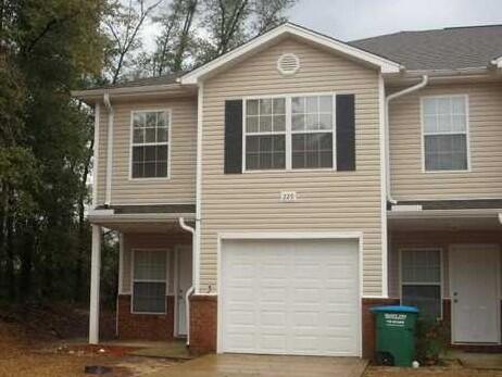 a front view of a house with a garage