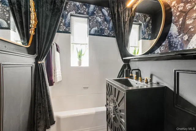 a bathroom with a sink a mirror and a bathtub