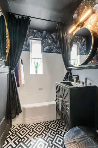 a bathroom with a sink a mirror and a bathtub