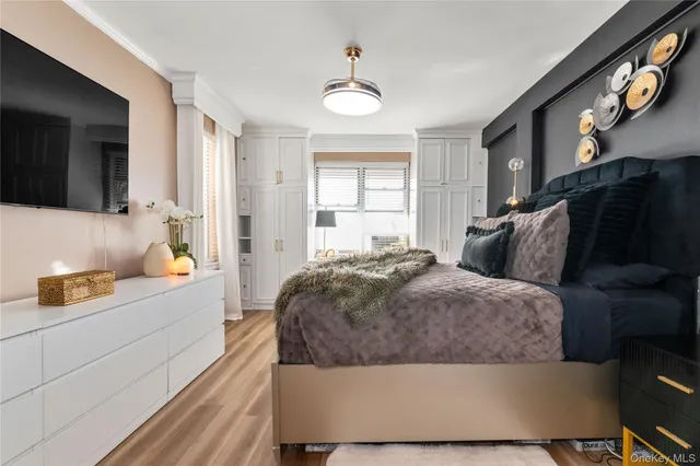 a living room with a bed furniture and a flat tv screen