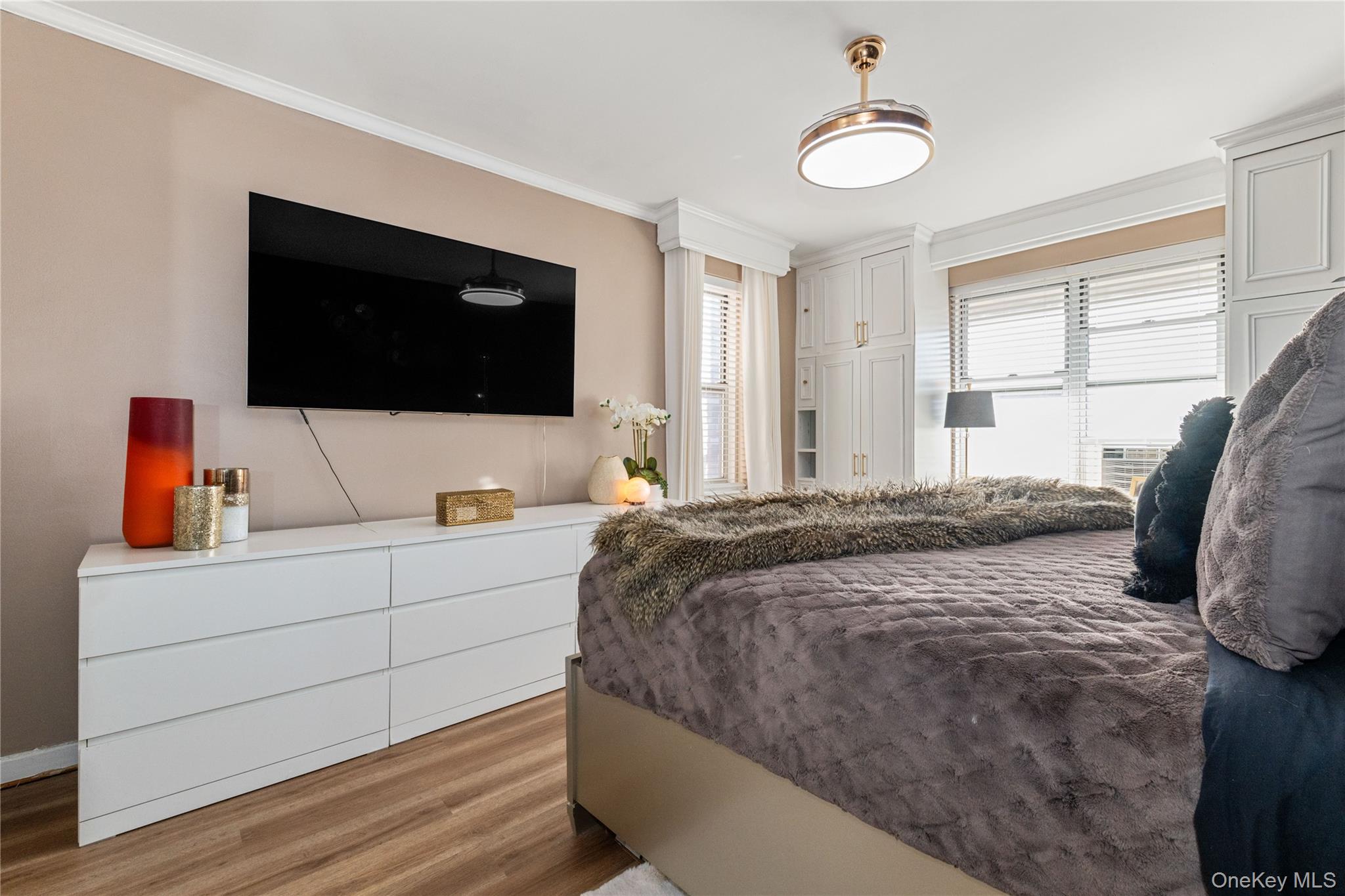 83-33 Austin Street, Unit 3D Queens, NY 11415 - Photo 15 of 20 a bedroom with a bed and a flat screen tv