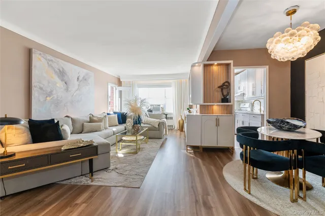 a living room with furniture and a chandelier