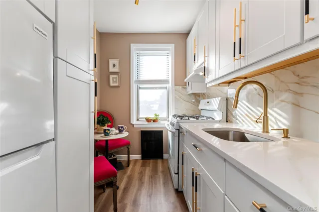 a kitchen with a sink cabinets and appliances