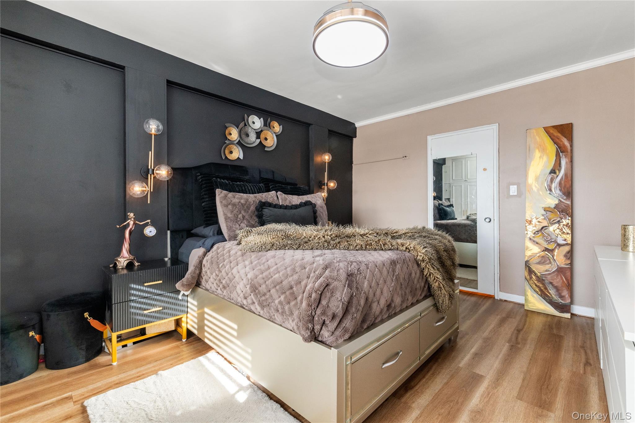 83-33 Austin Street, Unit 3D Queens, NY 11415 - Photo 10 of 20 a spacious bedroom with a bed and a chandelier