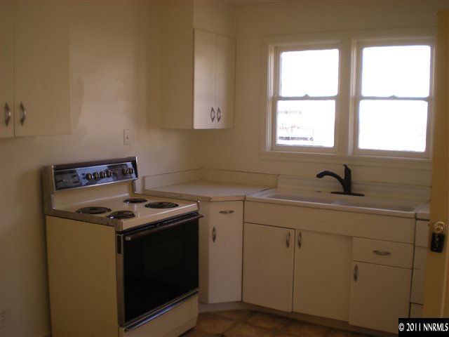 135-137 Caliente Street Reno, NV 89509 - Photo 12 of 13 a kitchen with a stove and white cabinets