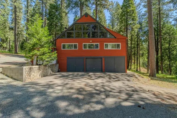 a view of a house with a yard and sitting area