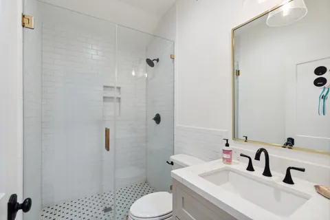 a bathroom with a sink toilet and shower