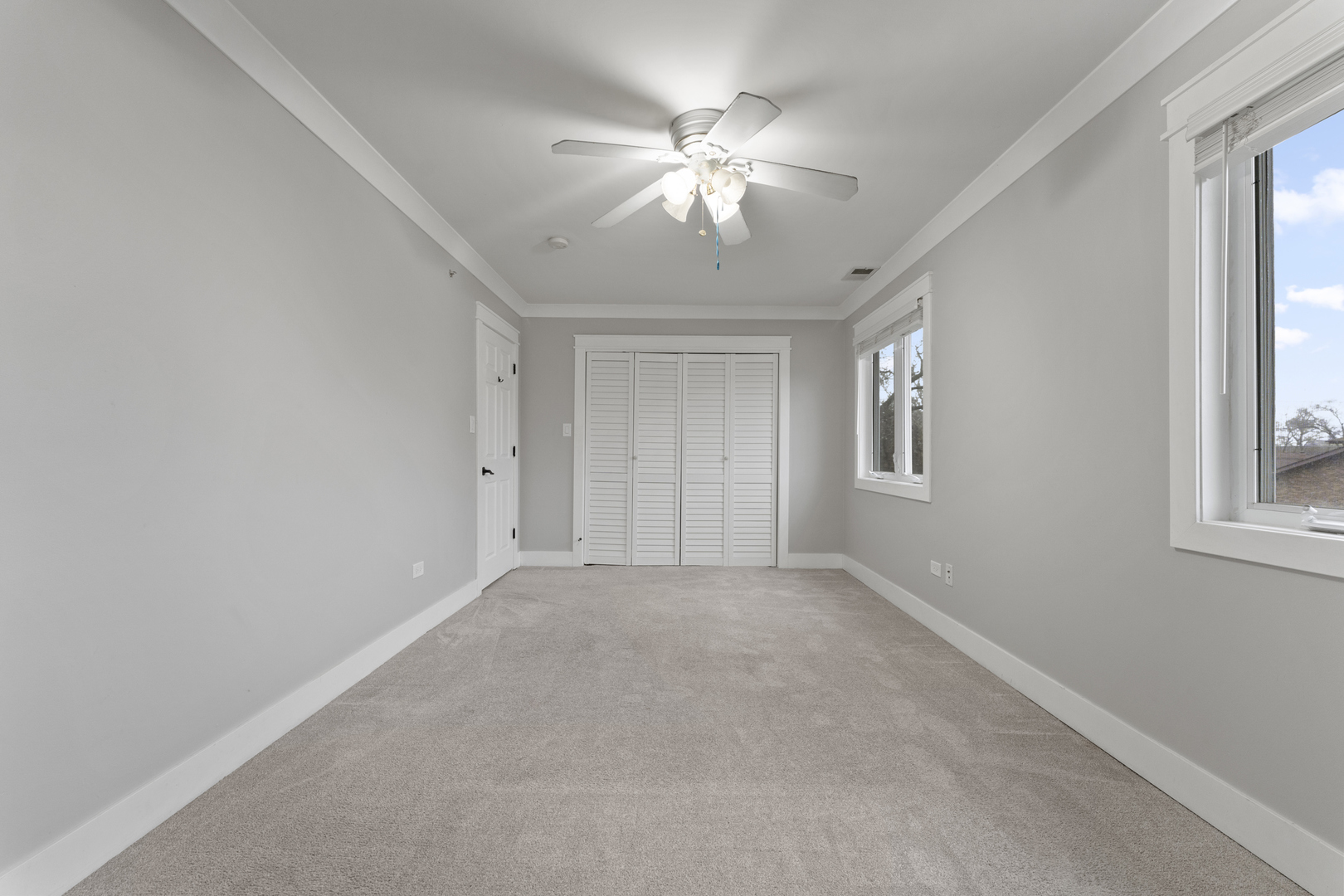 8306 South 82nd Avenue Justice, IL 60458 - Photo 19 of 40 an empty room with windows and chandelier fan
