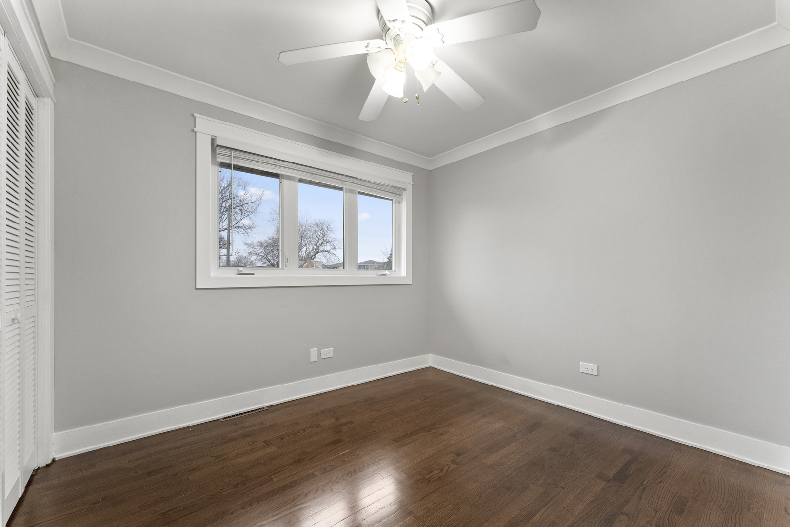 8306 South 82nd Avenue Justice, IL 60458 - Photo 20 of 40 a view of an empty room with wooden floor and a window