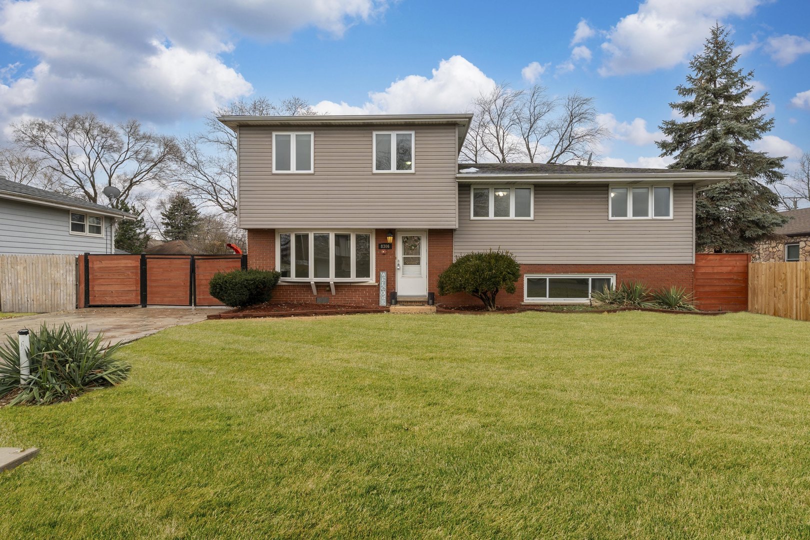 8306 South 82nd Avenue Justice, IL 60458 - Photo 2 of 40 a front view of a house with a garden