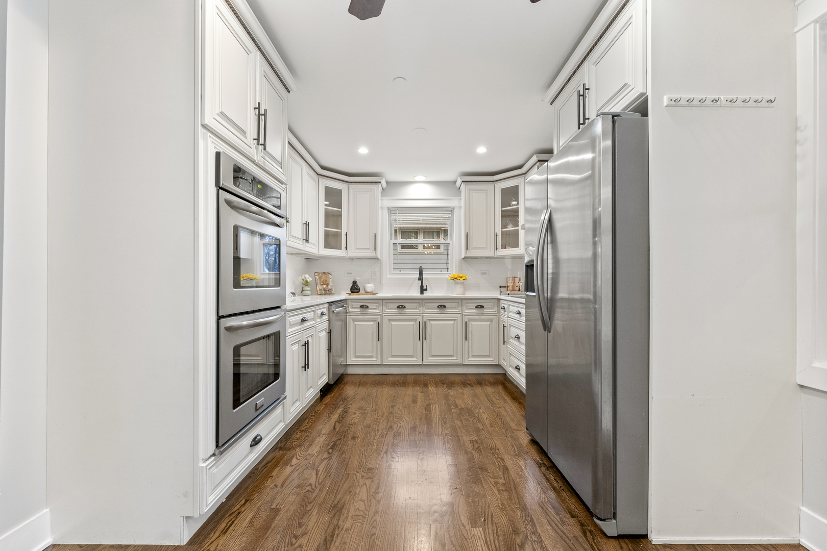8306 South 82nd Avenue Justice, IL 60458 - Photo 9 of 40 a kitchen with white cabinets and white appliances