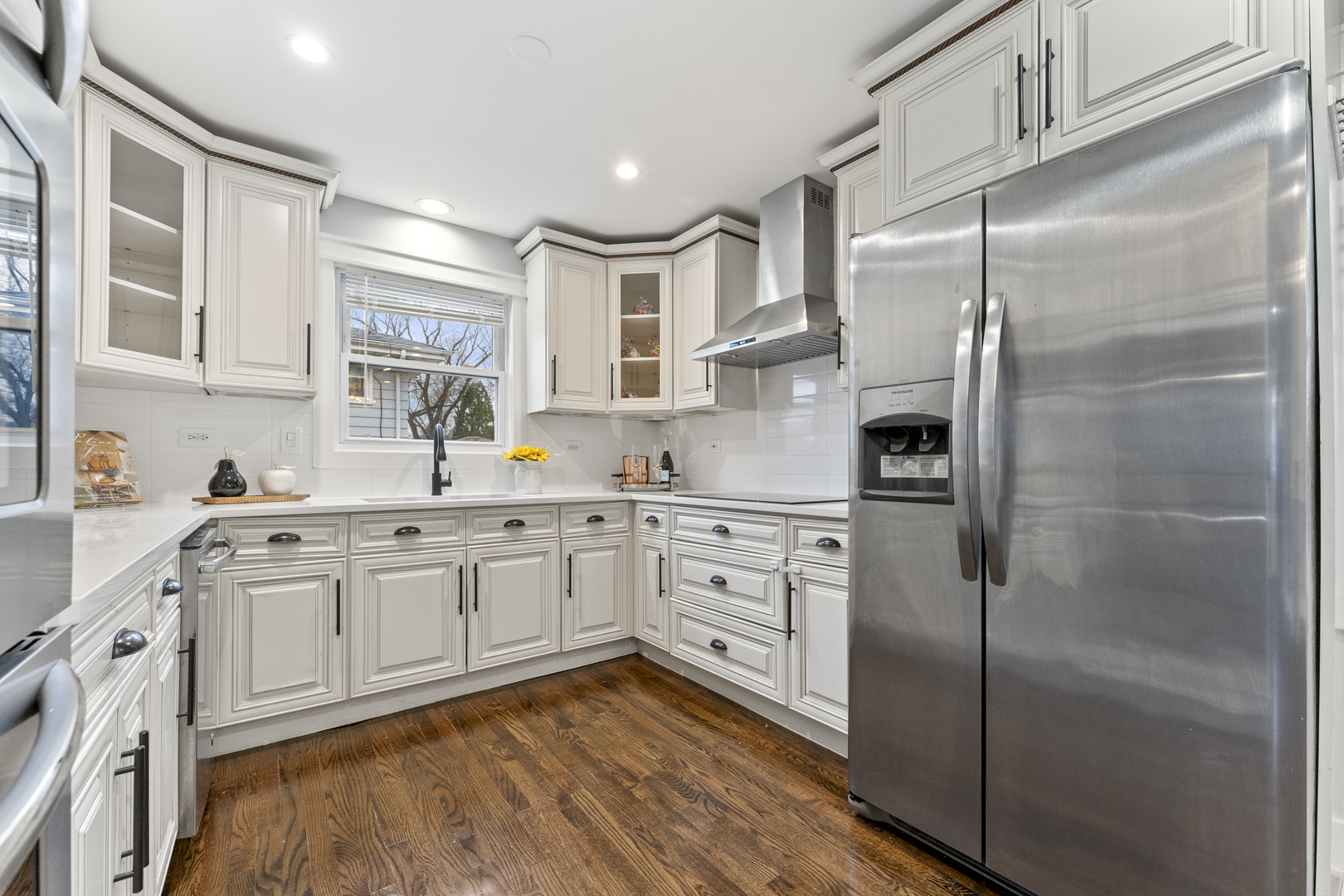 8306 South 82nd Avenue Justice, IL 60458 - Photo 10 of 40 a kitchen with stainless steel appliances granite countertop a refrigerator sink and white cabinets