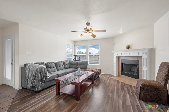 a living room with furniture and a fireplace