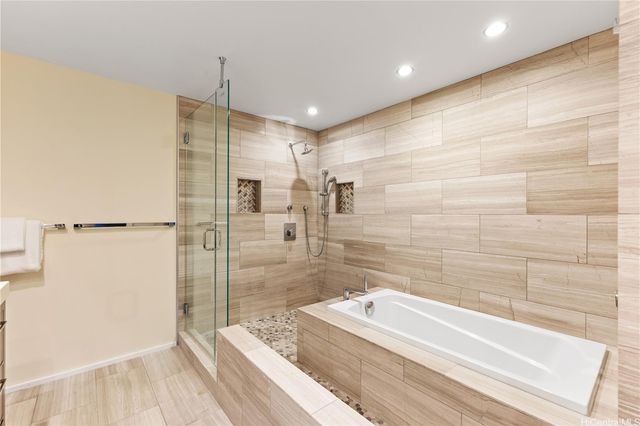a bathroom with a tub and a shower
