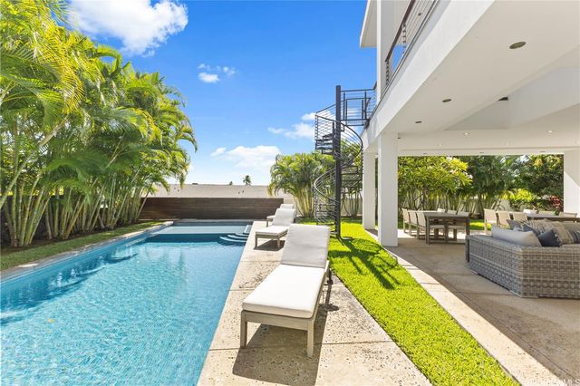 a view of swimming pool with a patio and couches chairs