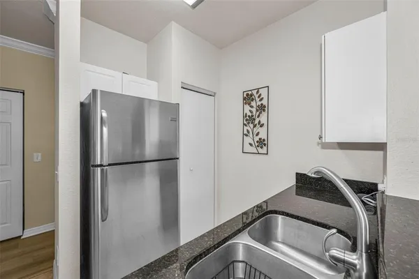 a white refrigerator freezer sitting inside of a kitchen