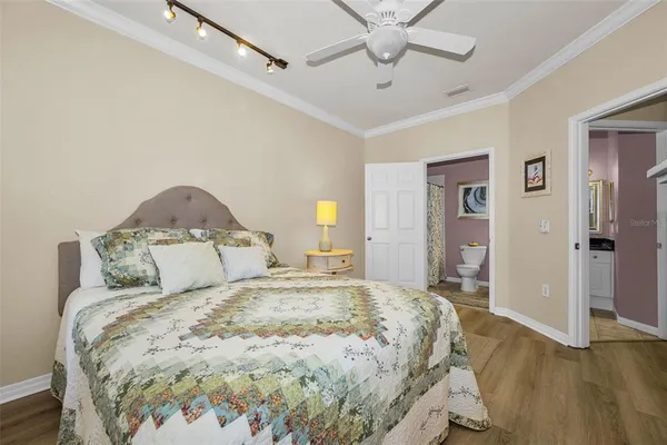 a large bed sitting in a bedroom and a chandelier