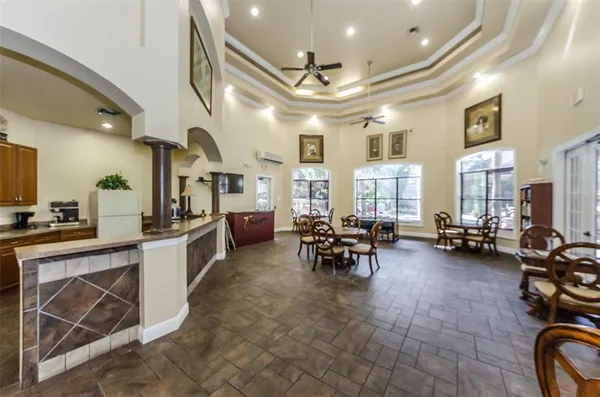 a room with pool table table and windows