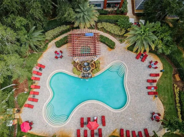 a view of a swimming pool with sitting area