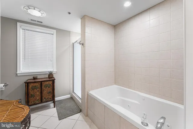 a bathroom with a tub shower and sink