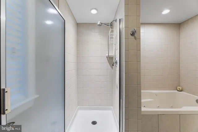 a spacious bedroom with a bed and a chandelier