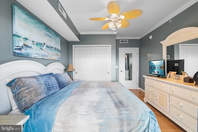 a bedroom with a bed a window and a chandelier